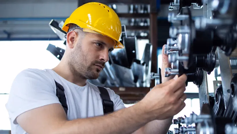 Technician performing maintenance on a generator set to prevent breakdowns and ensure proper operation